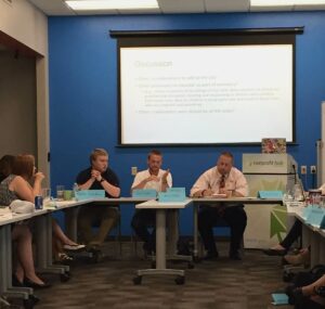 Project Everlast members, Payne and Jared (front, left) speak to the group and answer questions about their experiences growing up in foster care.